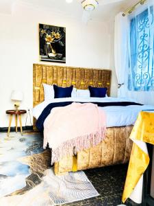 a bedroom with a large bed with blue curtains at Heart of the City Private Room with Amazing Views, Fast WiFi ,AC and walkable in Dar es Salaam