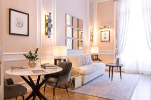a living room with a couch and a table at Grand Hotel Principe Di Piemonte in Viareggio