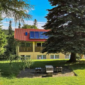 a house with a red roof with solar panels on it at Ośrodek Wypoczynkowy "Przy Lesie" in Karpacz