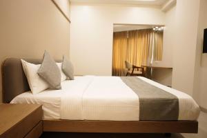Letto o letti in una camera di A Square Executive Hotel
