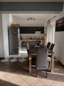 a kitchen with a dining room table and chairs at Sea View Apartment Sunrise Poljica & Blue Lagoon Rent A Boat in Poljica