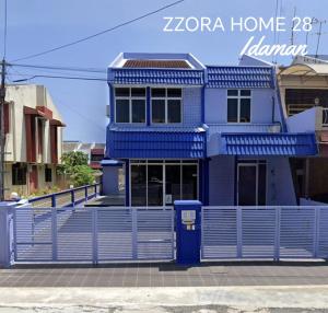 a blue house with a fence in front of it at Zzz Home in Alor Setar