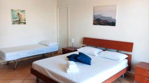 a bedroom with two beds with towels on them at Casa Granata in Trapani