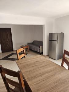 a living room with a table and a refrigerator at Traflor Termhouse in Venus +39 photos
