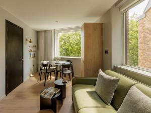 a living room with a couch and a table at Wilde Cambridge City Centre in Cambridge +76 photos