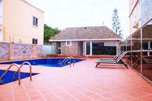 a patio with a swimming pool next to a building at EYIRBA in Bawaleshi