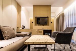 a living room with a couch and a tv at Michid 2 Hotel in Ulaanbaatar
