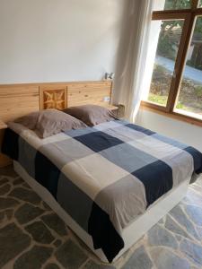 a large bed in a bedroom with a window at Casa costa de Lugo frente al mar in Nois