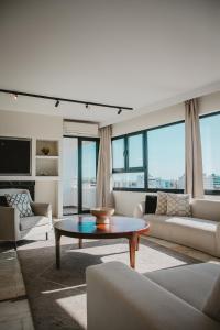 a living room with a couch and a coffee table at Amber View Penthouse 220sqm- overlooking downtown in Limassol