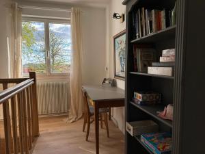 a room with a table and a book shelf at Villa l'Escale in Daubeuf-Serville