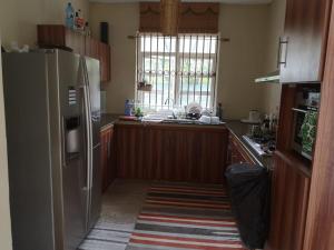 a kitchen with a stainless steel refrigerator and a sink at La Gaulette Seaview Villa in La Gaulette