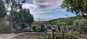a fence in a yard with a view of a city at Casa Margherita in Pairola