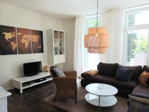 a living room with a couch and a tv at Ferienwohnung Lampe in Bad Essen