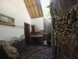a hallway of a room with a stone wall at Abdi Fantastik in Gili Islands