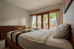 Postel nebo postele na pokoji v ubytování Pondok Canggu Guest house