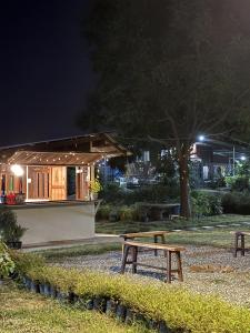 una mesa de picnic en un parque por la noche en BanYat Farm Stay, 