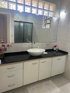 a bathroom with a sink and a large mirror at Refúgio na Capital in Curitiba +24 photos