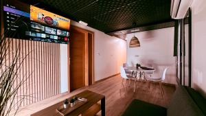 a dining room with a table and white chairs at Apartamentos villa Carolina in Porriño