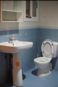 a bathroom with a white toilet and a sink at Hoceima in Al Hoceïma