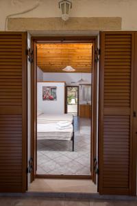 an open door to a bedroom with a bed at Stefanos Studios in Skala