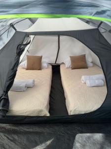 a black tent with two beds in it at Camping Tent JUNIOR in Danilovgrad