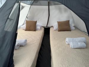 a tent with two beds and pillows in it at Camping Tent JUNIOR in Danilovgrad