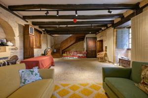a large living room with a table and chairs at Le Mayne in Beynac-et-Cazenac +3 photos