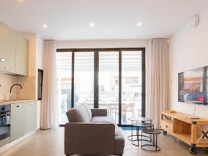 a living room with a couch and a table at Villa Luma With Heated Pool, Jacuzzi, Gym, Sauna and Cinema Room in Sliema