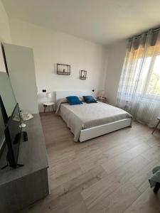 a bedroom with a bed with blue pillows on it at Guest House Sant'Antonio 