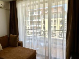 a room with a window with a view of a building at Menada Diamant Apartments in Sunny Beach +42 photos