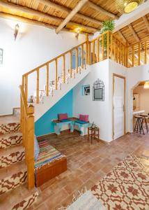 a living room with stairs and a blue and white wall at Casa JuKa - Private Algarve Home with Pool, Garden & Sea View in Olhão