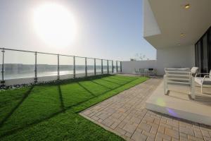 a balcony of a building with a view of the ocean at Silk Valley - 4B near Al Hamriyah | private beach access in Sharjah