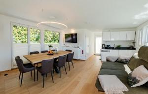 a dining room and living room with a table and a couch at ANKERLOFT - Hausboot in Hannover