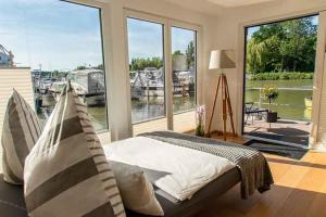 a bedroom with a bed and a large window at ANKERLOFT - Hausboot in Hannover +4 photos