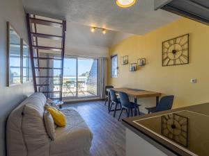 a living room with a couch and a table at Ty Fox by Madame est Servie in Perros-Guirec