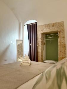 a bedroom with a large bed with a shower at ALLE TERRAZZE di Castellana Grotte in Castellana Grotte