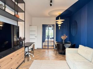 a living room with a couch and a table at Old Town Luxe Loft in Iaşi