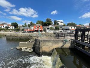 a dam in a river with water coming out of it at Maison du Chêne in Vertou