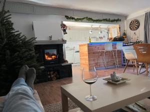 a person laying on a table in a living room with a fireplace at Kamocsay Vendégház in Mór