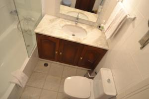 a bathroom with a sink and a toilet and a shower at Apartments Miramare Miramonte in Carvoeiro
