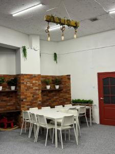 a room with a table and chairs and a red door at WooW kids club in Rīga