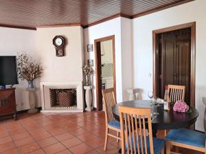 a dining room with a table and chairs and a fireplace at Apartment Dom Carlos by Interhome in Cascais