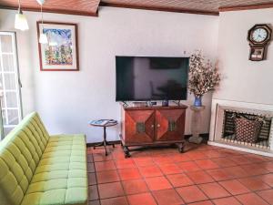 a living room with a flat screen tv and a couch at Apartment Dom Carlos by Interhome in Cascais
