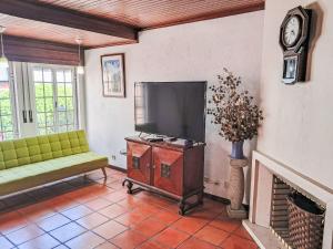 a living room with a flat screen tv and a fireplace at Apartment Dom Carlos by Interhome in Cascais +11 photos