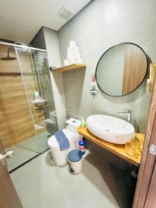 a bathroom with a toilet and a sink and a mirror at 405MSNK Maison Luxe Twin Studio l Balcony & Kitchen in Can Tho +12 photos