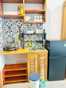 a small kitchen with a refrigerator and a sink at 405MSNK Maison Luxe Twin Studio l Balcony & Kitchen in Can Tho