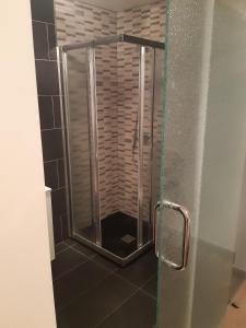 a shower with a glass door in a bathroom at Apartment 3 Bedrooms Heated Pool in Adeje