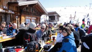 a group of people sitting at tables in front of a ski lodge at Skihütte Silberleiten, 8 Personen in Krimml +17 photos