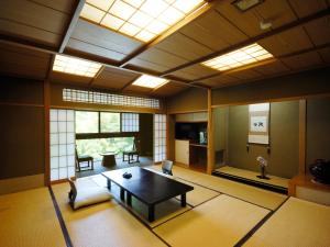 a living room with a table and chairs in it at Momoyama in Matsumoto