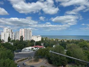 a view of a city with tall buildings and the ocean at Chornomorsk Apartment in Chornomorsk